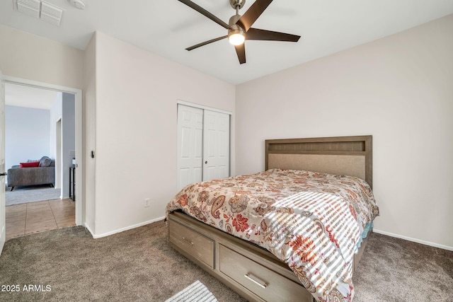 bedroom featuring carpet flooring, a closet, baseboards, and ceiling fan