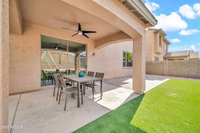 view of patio featuring a ceiling fan and outdoor dining area