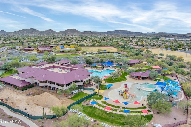 drone / aerial view of a mountainous background and a pool
