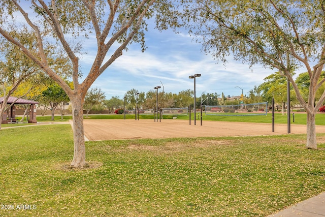 surrounding community with volleyball court, a gazebo, and a lawn