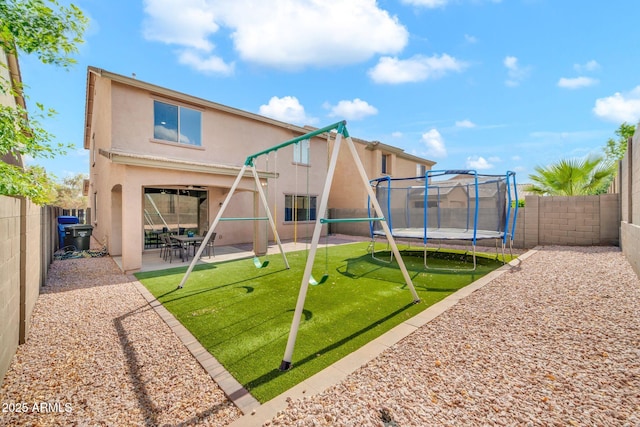 view of playground featuring a trampoline and a patio