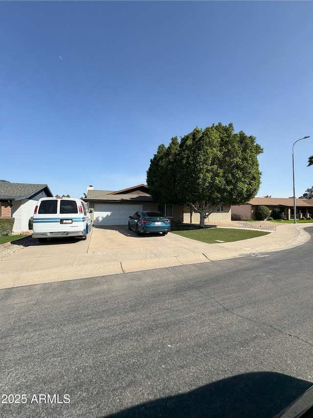 obstructed view of property with driveway