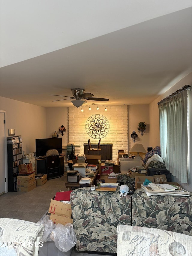 living room with ceiling fan and tile patterned flooring