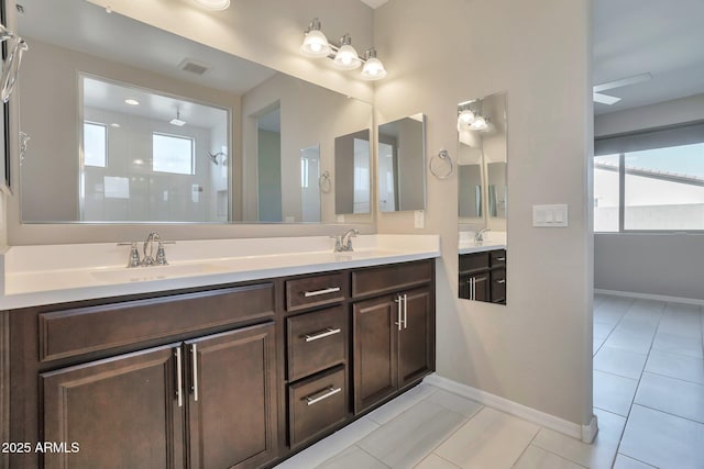 bathroom with vanity, tile patterned flooring, and walk in shower