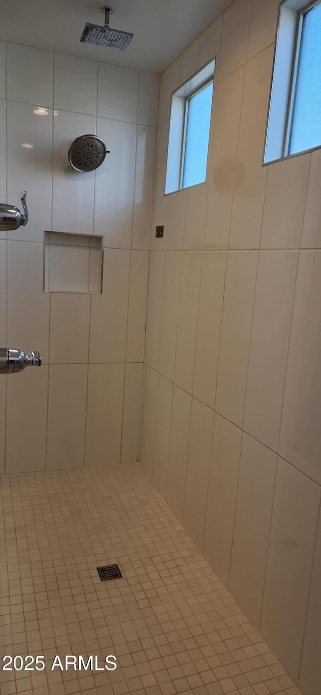 bathroom with tiled shower