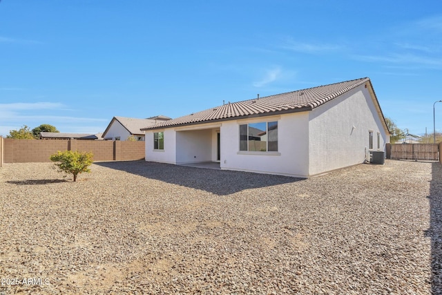 back of house featuring central AC and a patio area