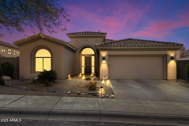 mediterranean / spanish-style home with a garage