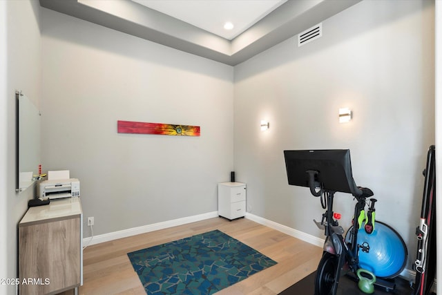 workout room featuring light hardwood / wood-style flooring