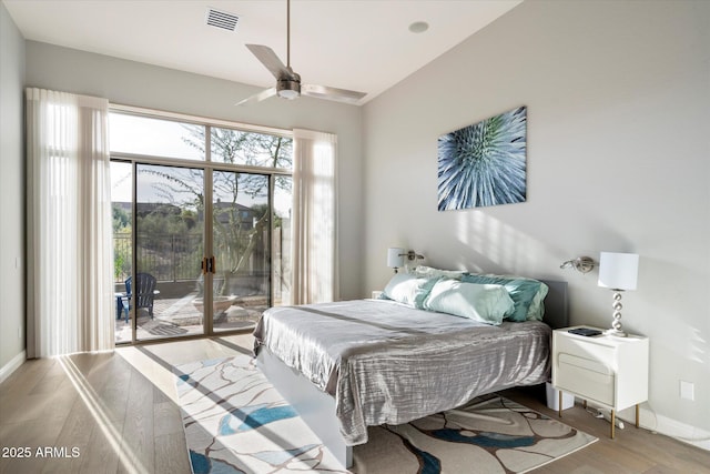 bedroom featuring ceiling fan, access to exterior, and light hardwood / wood-style floors