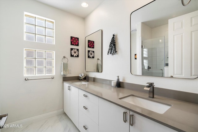 bathroom featuring vanity and a shower with door