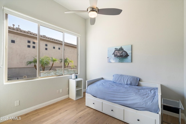 bedroom with ceiling fan and light hardwood / wood-style floors