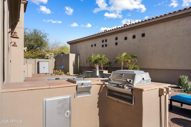 view of patio with exterior kitchen and grilling area