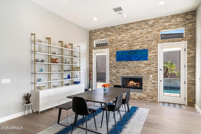 dining room featuring a fireplace and hardwood / wood-style floors