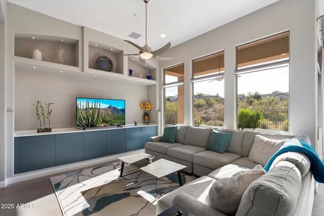 living room featuring ceiling fan and hardwood / wood-style floors