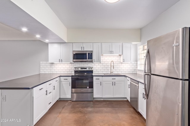 kitchen featuring white cabinetry, stainless steel appliances, tasteful backsplash, and sink