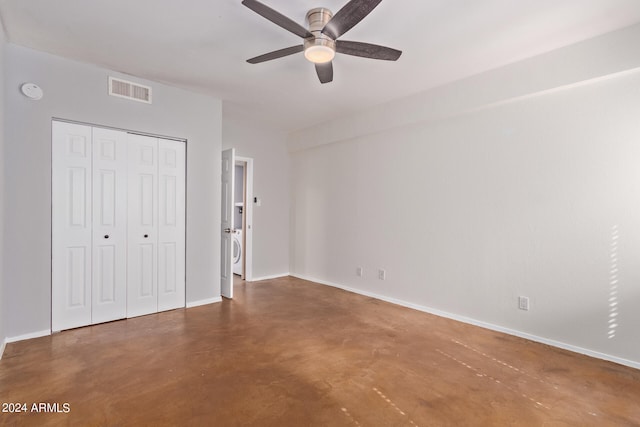 unfurnished bedroom featuring a closet, ceiling fan, and washer / clothes dryer