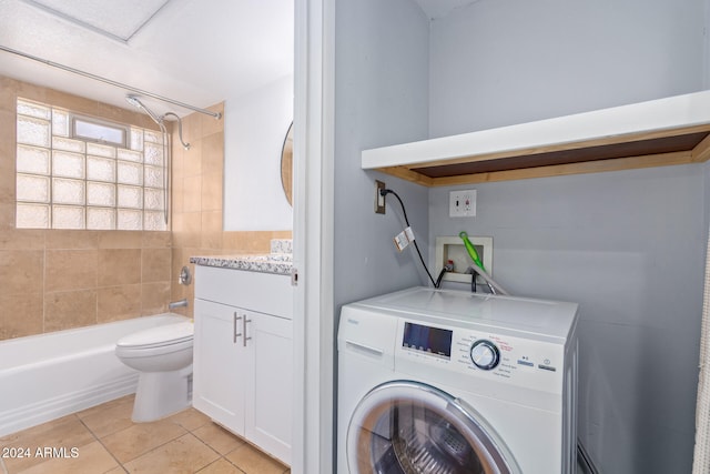 washroom featuring light tile patterned floors and washer / clothes dryer