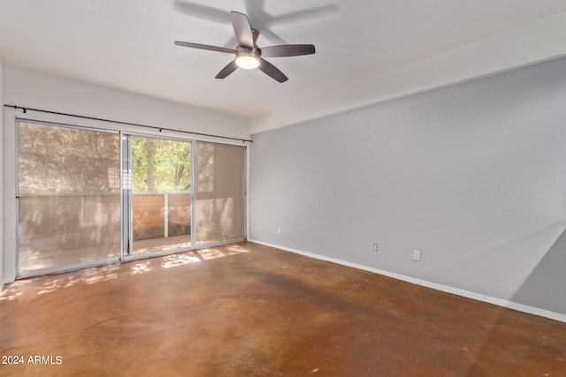 spare room featuring concrete floors and ceiling fan