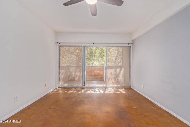 spare room featuring concrete floors and ceiling fan