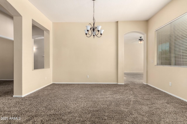 unfurnished room with carpet, a chandelier, ceiling fan, baseboards, and arched walkways
