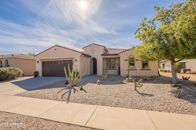 2599 E San Mateo Dr, Casa Grande, AZ 85194 - mediterranean / spanish home with concrete driveway, an attached garage, stucco siding, and a tile roof