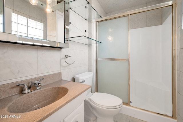 bathroom featuring walk in shower, vanity, tile walls, tile patterned flooring, and toilet