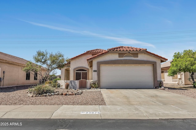 23075 W Arrow Dr, Buckeye, AZ 85326 - mediterranean / spanish-style house with an attached garage, a tiled roof, stucco siding, and concrete driveway