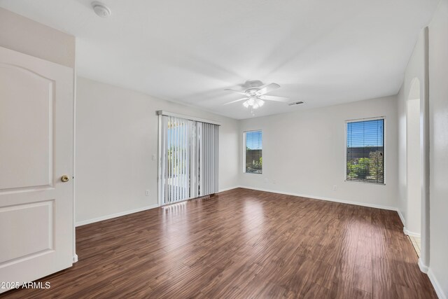 23075 W Arrow Dr, Buckeye, AZ 85326 - empty room featuring a smoke detector, a ceiling fan, and dark wood-style floors