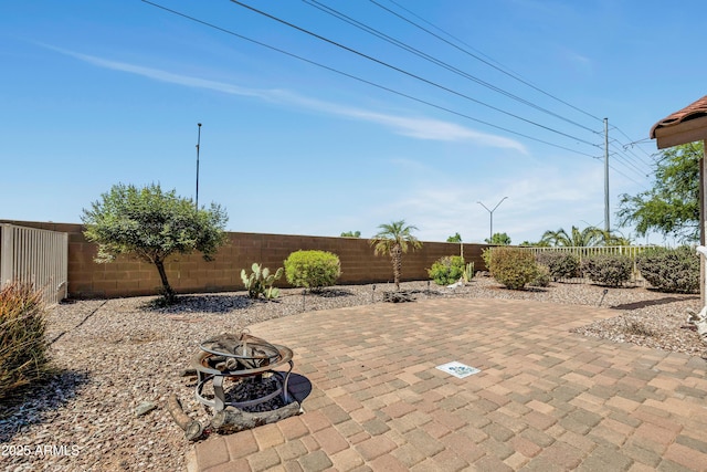 23075 W Arrow Dr, Buckeye, AZ 85326 - fenced backyard featuring a fire pit and a patio