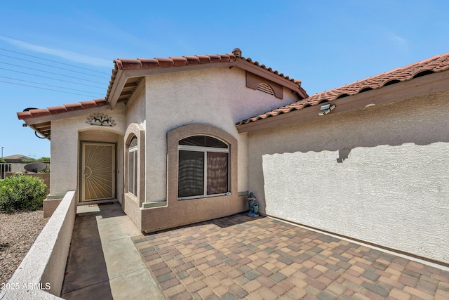 23075 W Arrow Dr, Buckeye, AZ 85326 - entrance to property featuring stucco siding, a tiled roof, and a patio