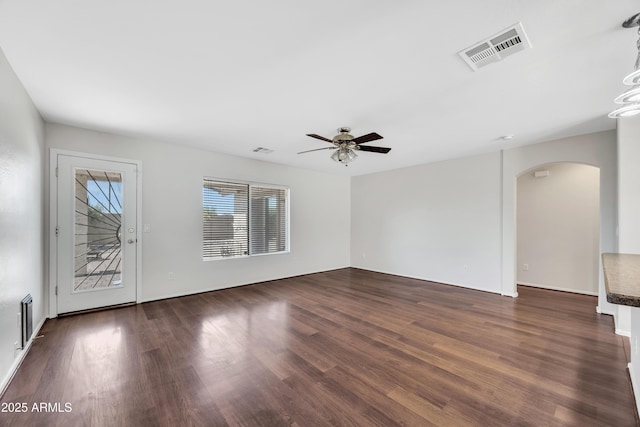 23075 W Arrow Dr, Buckeye, AZ 85326 - empty room with arched walkways, wood finished floors, and ceiling fan