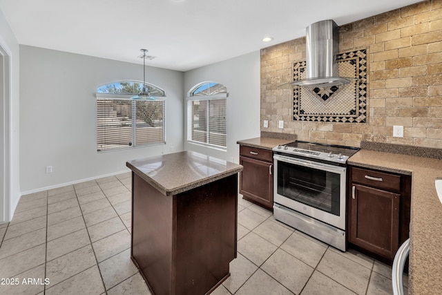 23075 W Arrow Dr, Buckeye, AZ 85326 - kitchen with stainless steel range with electric cooktop, wall chimney exhaust hood, light tile patterned flooring, backsplash, and recessed lighting