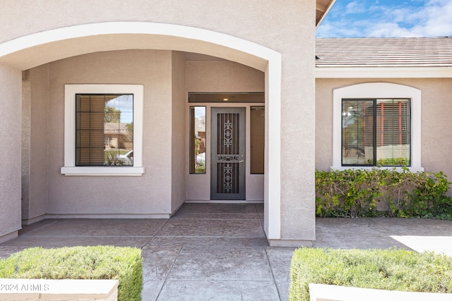 entrance to property with a patio