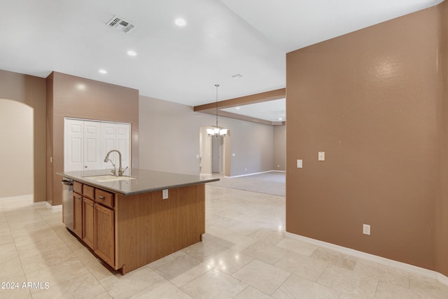 kitchen with sink, hanging light fixtures, a chandelier, stainless steel dishwasher, and a center island with sink