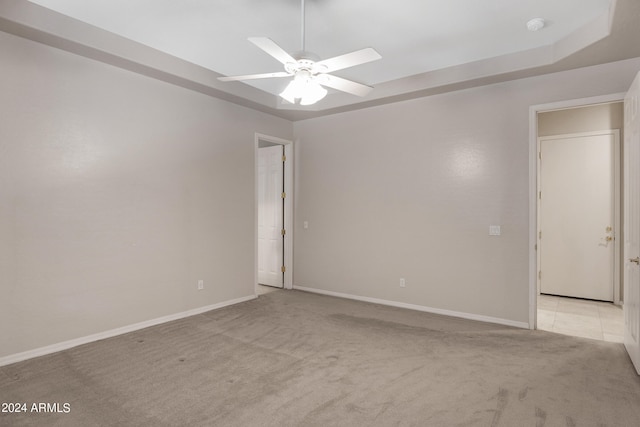 spare room with light carpet and ceiling fan