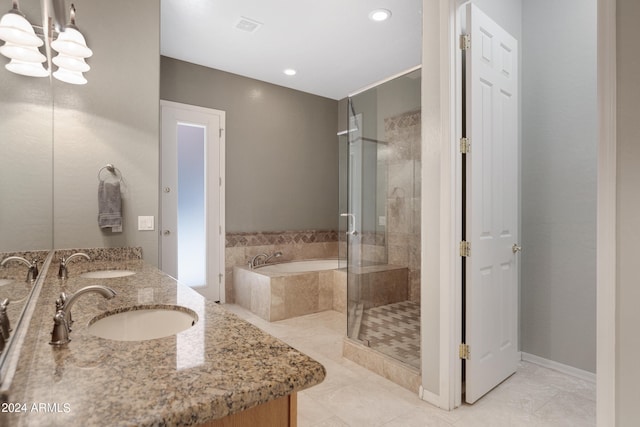 bathroom with tile patterned floors, vanity, a notable chandelier, and separate shower and tub