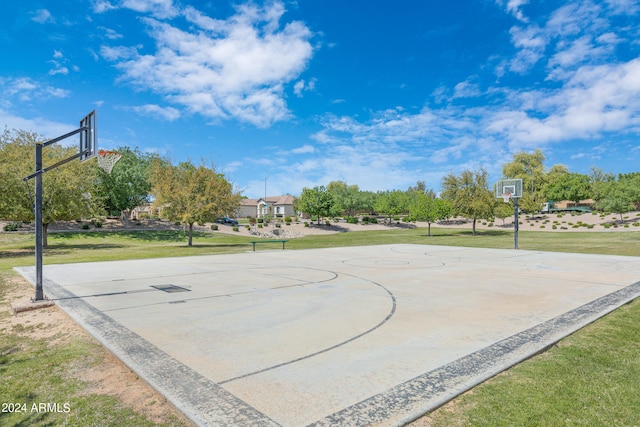 view of basketball court with a lawn