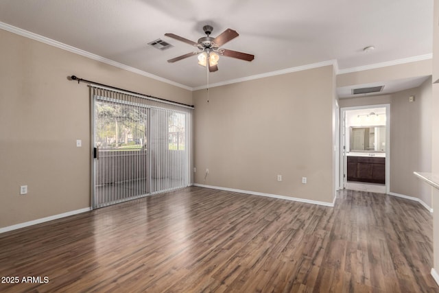 unfurnished room featuring visible vents, wood finished floors, and ornamental molding