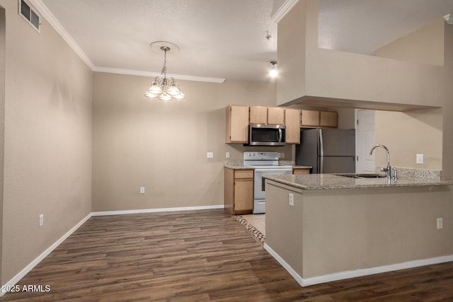 kitchen with appliances with stainless steel finishes, light brown cabinets, a sink, and visible vents