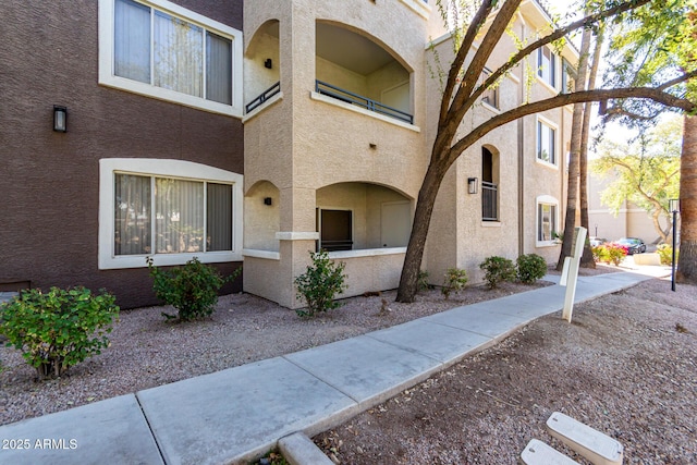 exterior space featuring fence and stucco siding