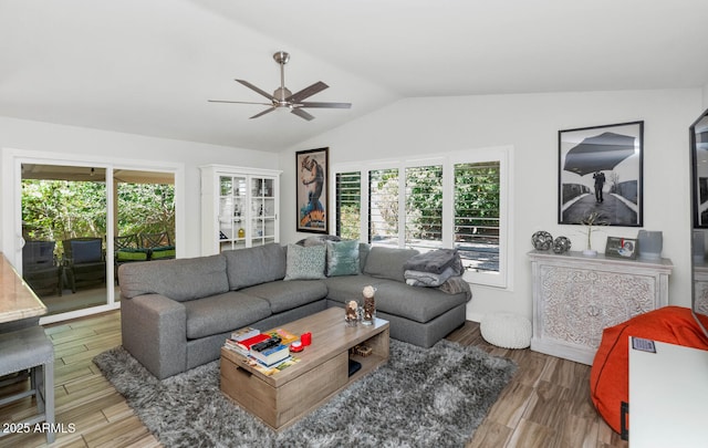 7806 N Via Del Sol, Scottsdale, AZ 85258 - living room featuring a ceiling fan, vaulted ceiling, healthy amount of natural light, and wood finished floors