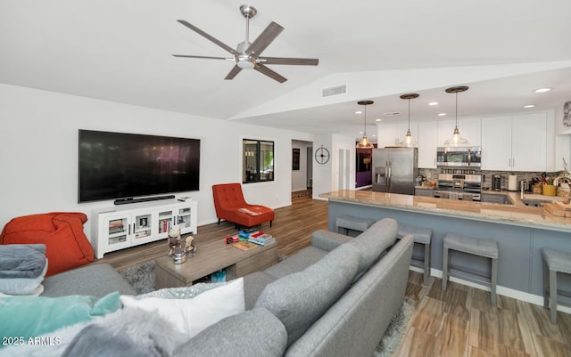 7806 N Via Del Sol, Scottsdale, AZ 85258 - living room with light wood finished floors, lofted ceiling, ceiling fan, and recessed lighting