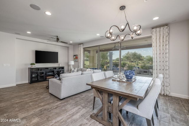 dining room with ceiling fan with notable chandelier and hardwood / wood-style floors