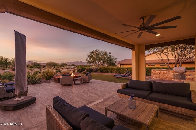 patio terrace at dusk with ceiling fan and an outdoor hangout area