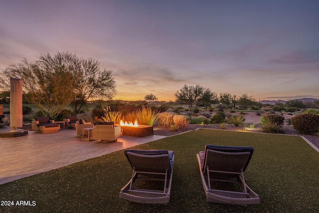 yard at dusk with a patio and a fire pit