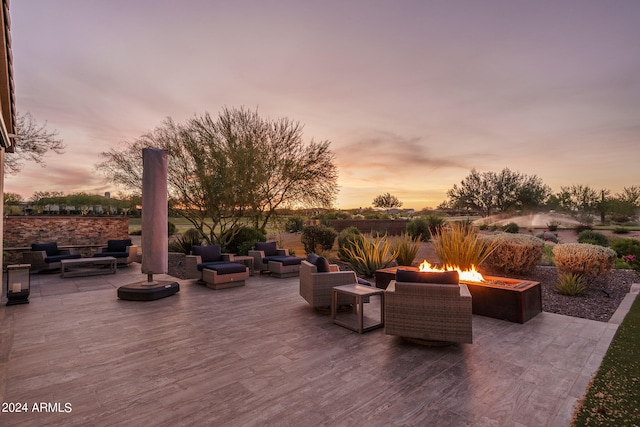 patio terrace at dusk featuring an outdoor fire pit