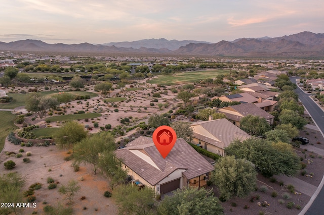 aerial view at dusk featuring a mountain view