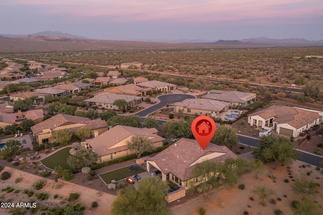 aerial view at dusk featuring a mountain view