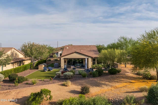 back of property featuring a lawn, a gazebo, a patio area, and an outdoor hangout area