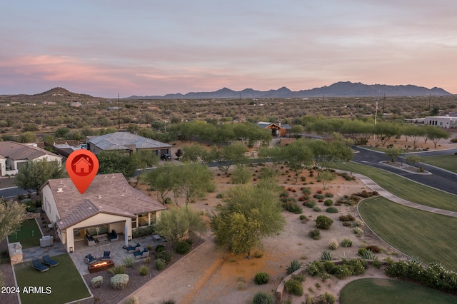 aerial view at dusk featuring a mountain view